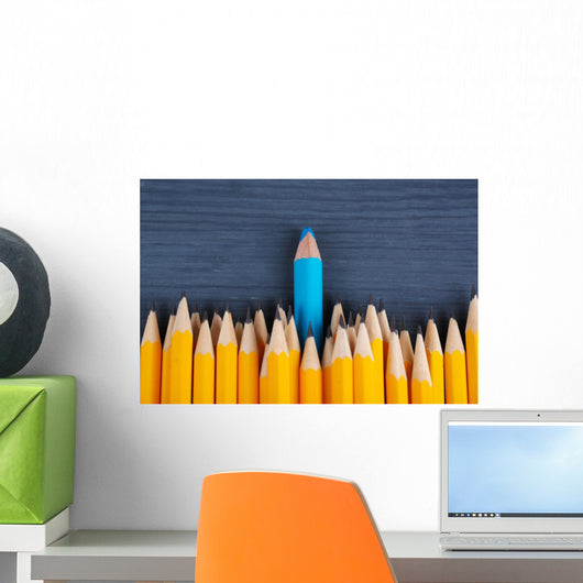 Celebratory pencil among usual pencils, on color background