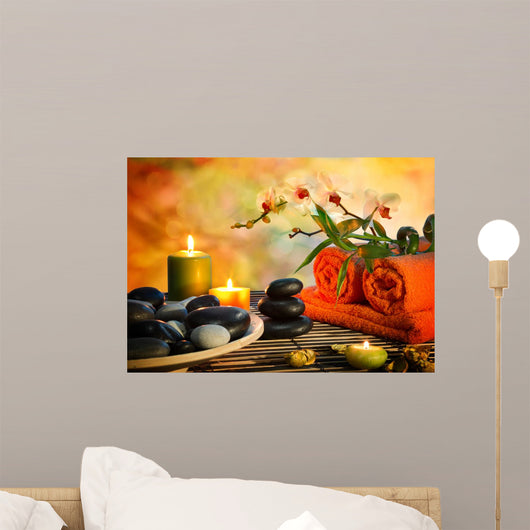 preparation for massage in orange lights and black stones
