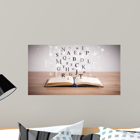 Opened book with flying letters