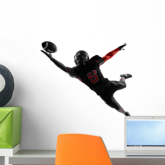 american football player catching ball silhouette