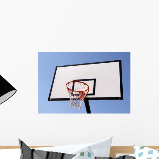 Outdoor basketball hoop against the blue sky Wall Mural