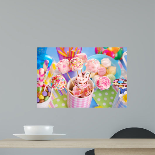 birthday party table with marshmallow pops and other sweets for