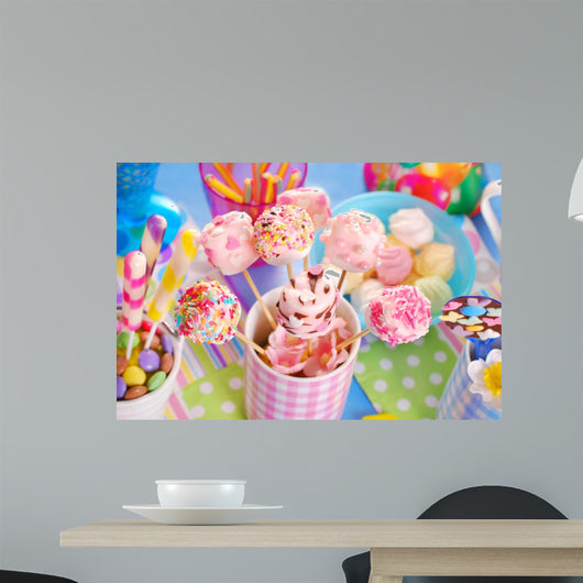 birthday party table with marshmallow pops and other sweets for