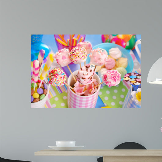 birthday party table with marshmallow pops and other sweets for