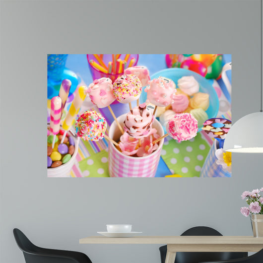 birthday party table with marshmallow pops and other sweets for