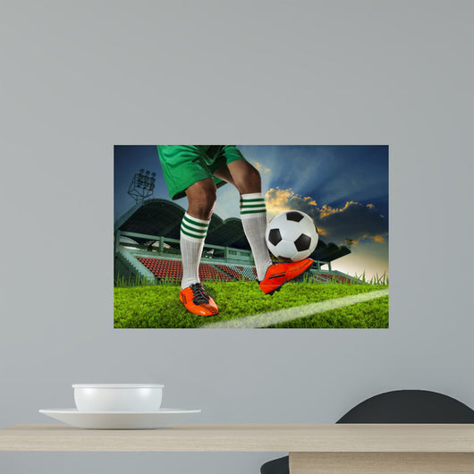 foot ball player holding foot ball on leg ankle on soccer sport
