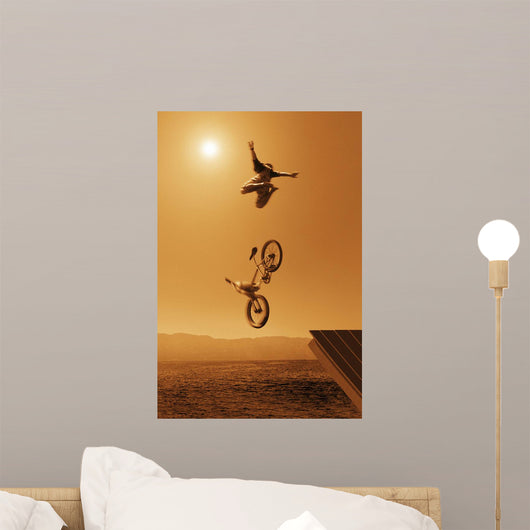 Cyclist Going Off Jump Into Water In Brown Tones Wall Mural