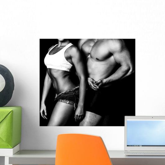 Strong woman and man against a black background Wall Mural