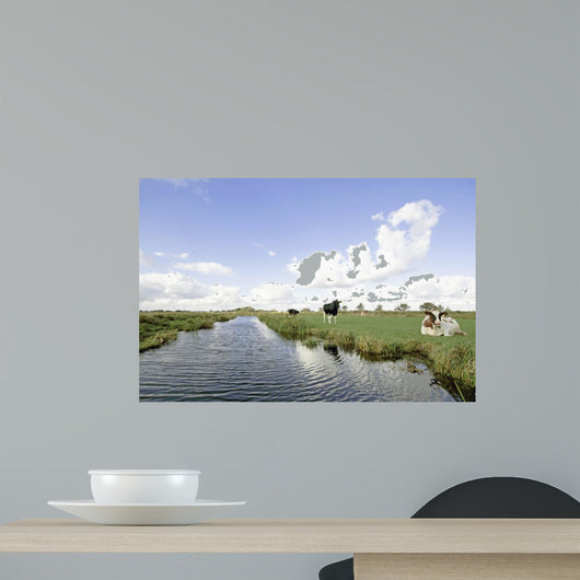 Typical wide dutch landscape with meadows, water and cloudscapes