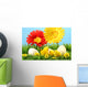 Easter chicks in the grass with flowers against a blue sky Wall Mural
