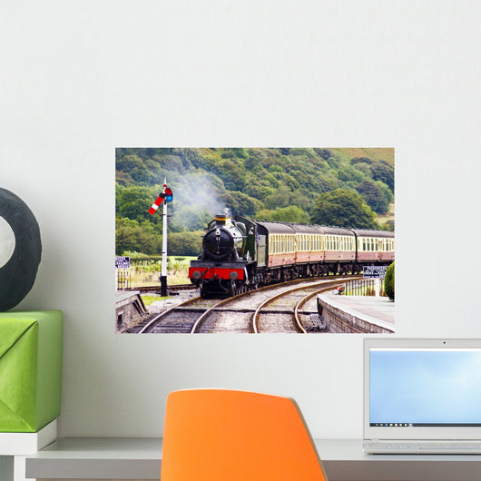 A steam train approaching the station Wall Mural