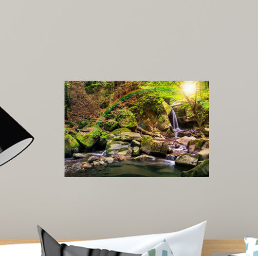 beautiful waterfall comes out of a huge rock in the forest Wall Mural