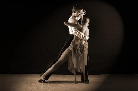 Latino dancers in ballroom against on black Wall Mural