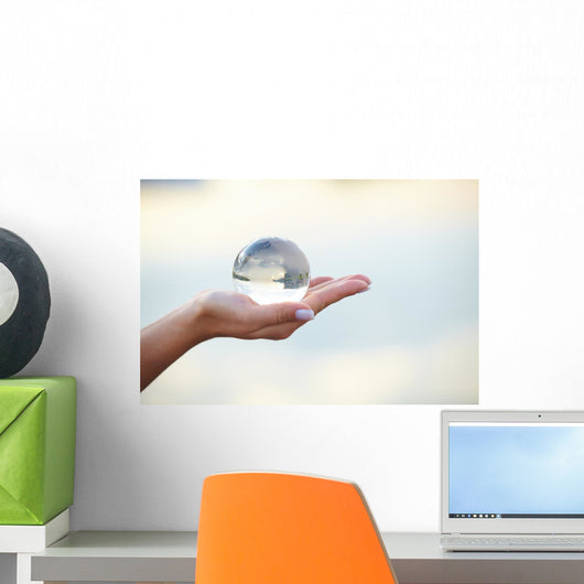 Crystal ball on hand Wall Mural