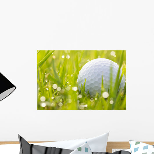 Golf ball on grass with water drops Wall Mural