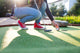 Young Woman Plays Adventure/Mini Golf In Summer Evening Wall Decal