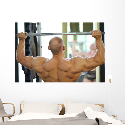 Back of Bodybuilder Raising Barbell in Gym Hall before Mirror Wall Mural