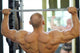 Back Of Bodybuilder Raising Barbell In Gym Hall Before Mirror Wall Decal