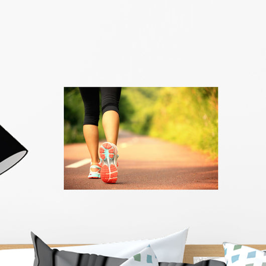 young fitness woman legs walking on forest trail  Wall Mural