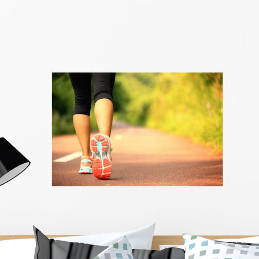 young fitness woman legs walking on forest trail  Wall Mural