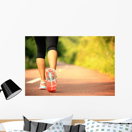 young fitness woman legs walking on forest trail  Wall Mural