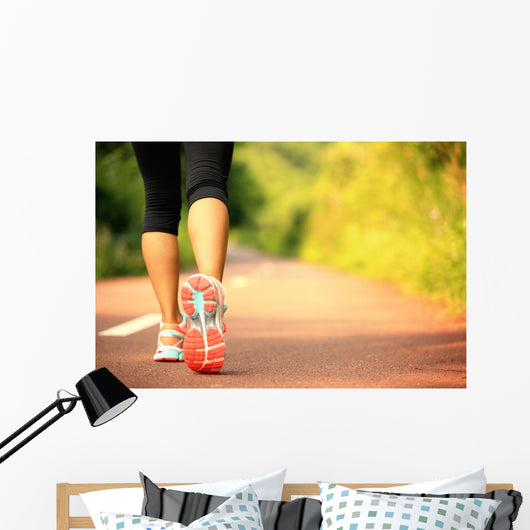 young fitness woman legs walking on forest trail  Wall Mural