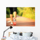 young fitness woman legs walking on forest trail  Wall Mural