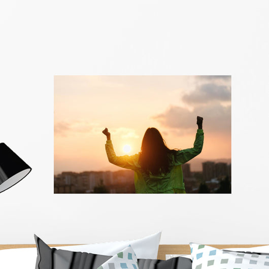Blissful woman celebrating sport and fitness lifestyle success Wall Mural