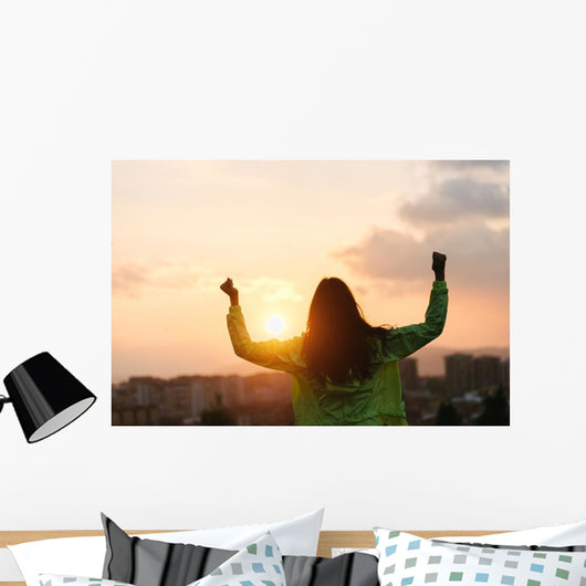 Blissful woman celebrating sport and fitness lifestyle success Wall Mural
