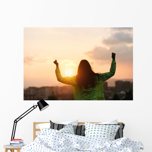 Blissful woman celebrating sport and fitness lifestyle success Wall Mural