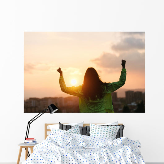 Blissful woman celebrating sport and fitness lifestyle success Wall Mural