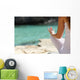 Detail of a woman hand doing yoga exercises on the beach Wall Mural