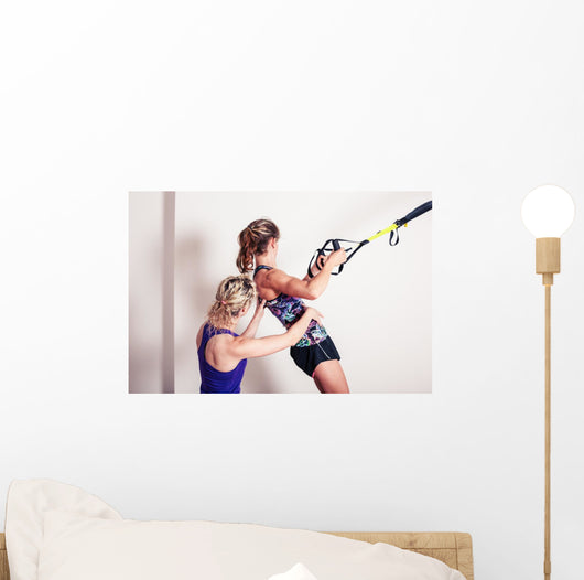 Athletic woman and personal trainer Wall Mural
