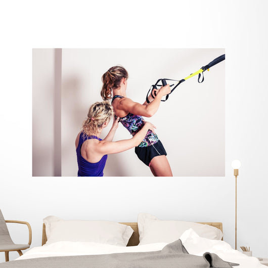 Athletic woman and personal trainer Wall Mural