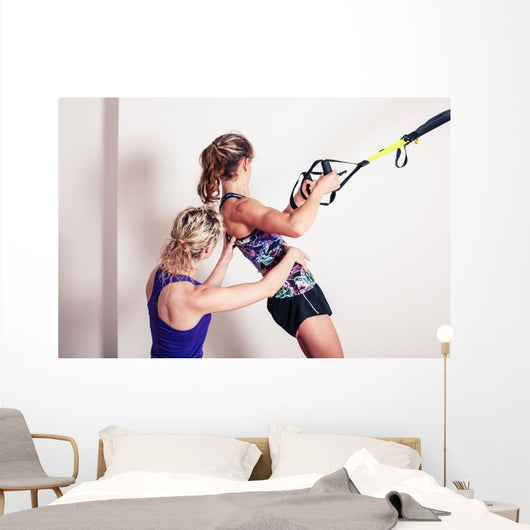 Athletic woman and personal trainer Wall Mural
