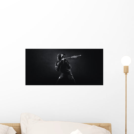 Paintballer shooting paintballgun Wall Mural