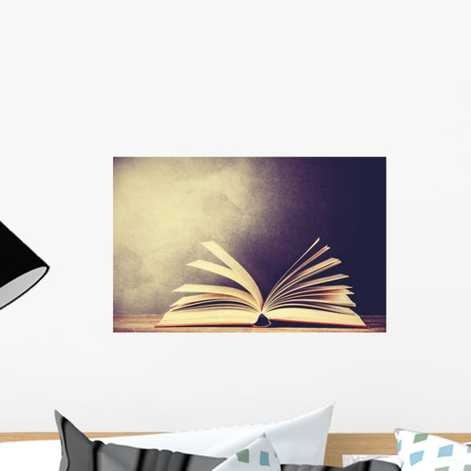 Opened book on a table. Wall Mural