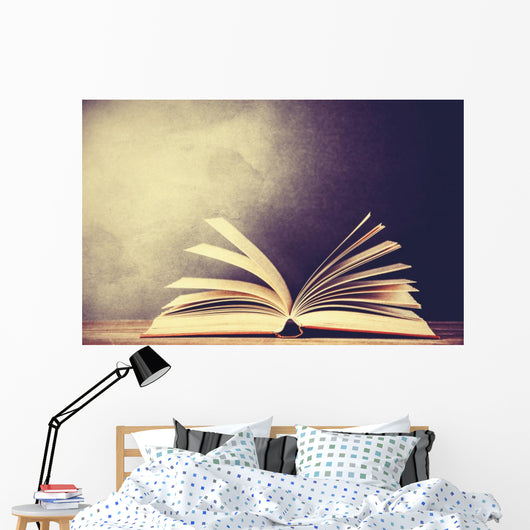 Opened book on a table. Wall Mural