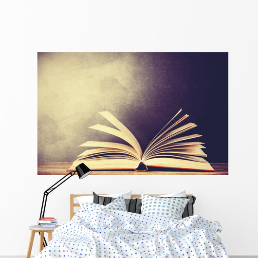 Opened book on a table. Wall Mural