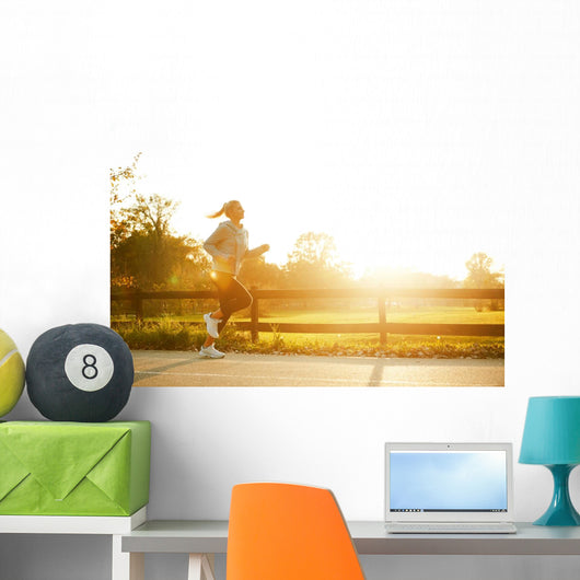 Jogging woman running in park  Wall Mural