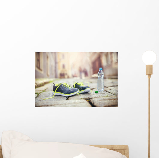 Running shoes and bottle of water Wall Mural