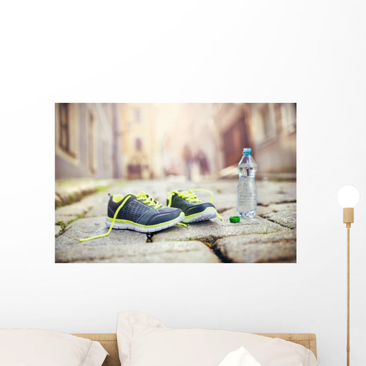 Running shoes and bottle of water Wall Mural