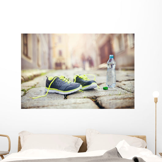 Running shoes and bottle of water Wall Mural