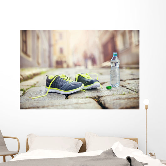 Running shoes and bottle of water Wall Mural