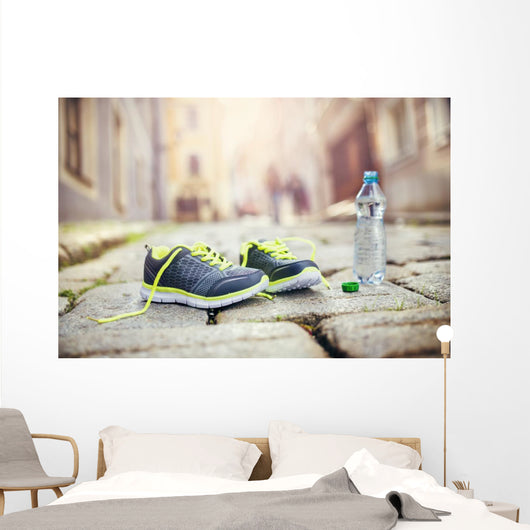 Running shoes and bottle of water Wall Mural