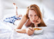 woman in bed eating chicken noodle soup while sick Wall Mural