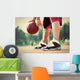 Young man on basketball court dribbling with bal Wall Mural