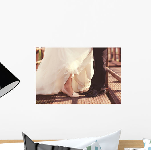 Bride and groom legs on a bridge Wall Mural