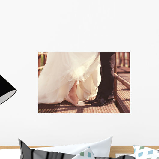 Bride and groom legs on a bridge Wall Mural