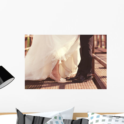 Bride and groom legs on a bridge Wall Mural